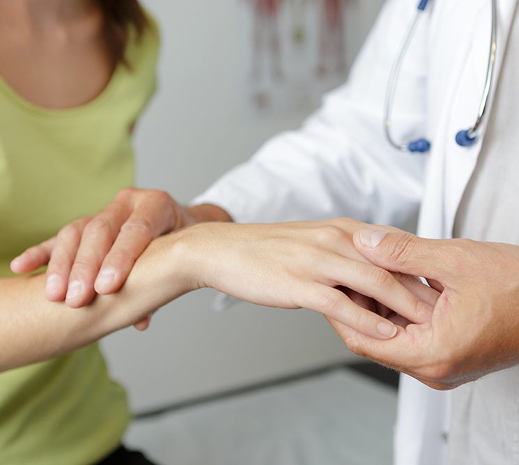 Doctor examining a patient's wrist