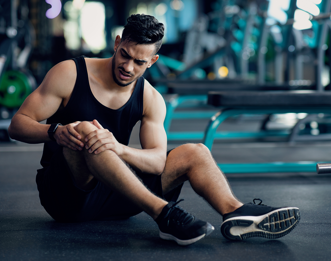 A young man with an injured knee